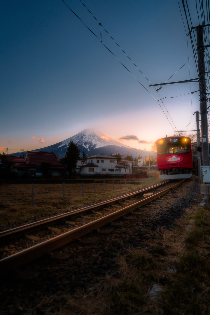 a train passing under mt fuji at twilight